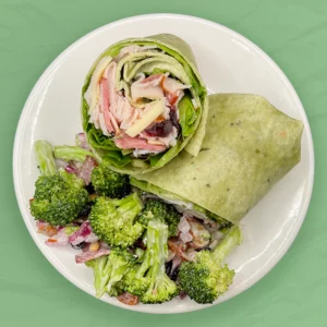 turkey harvest wrap on a plate with broccoli salad