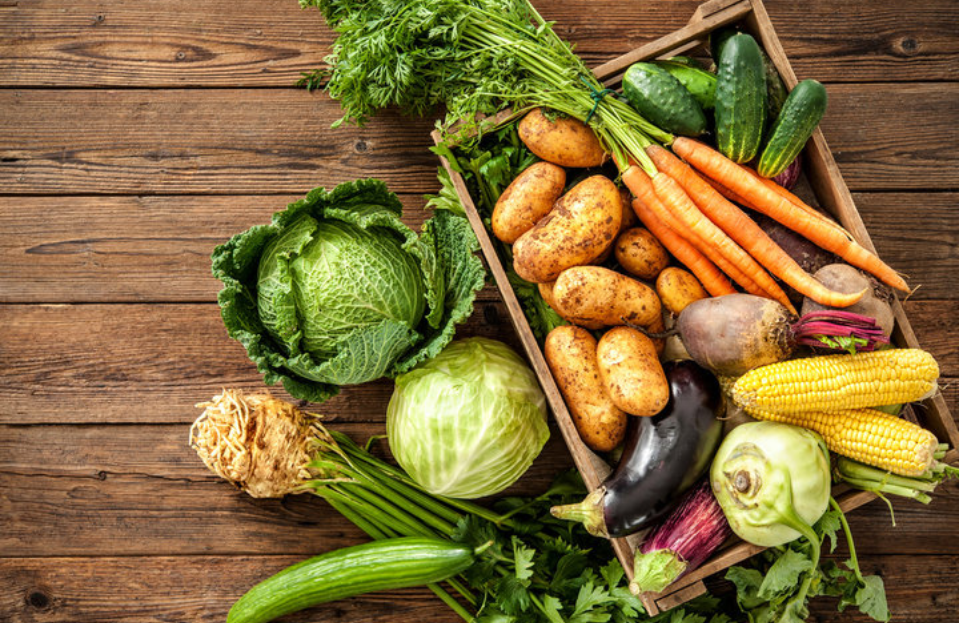 vegetables in a wooden box on a table