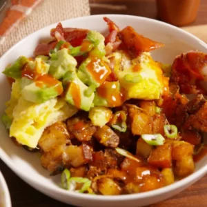 Russet Potatoes, Scrambled Eggs, Cheddar Cheese, Uncured Turkey Bacon, Sauteed Onion and Poblano Peppers, Sliced Green Onion and a Side of Salsa. 